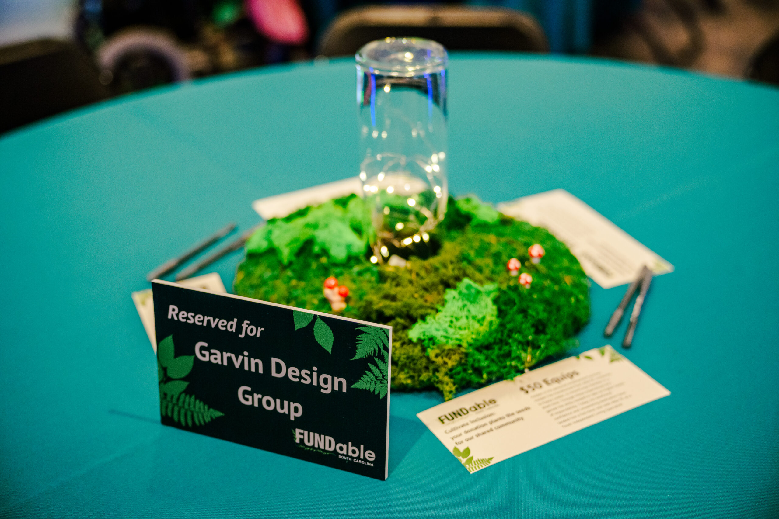 2023 Event centerpiece and tabletop display for a sponsored table.